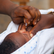 A child getting the oral polio vaccine at a health center in Lome, Togo.